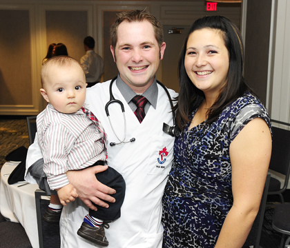 First-year veterinary student Paul Bienz celebrates with his wife and young son. Photo: Debra Marshall.