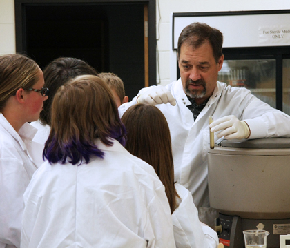 WCVM technician Brent Wagner shows VetMed campers how to conduct a fecal flotation. Photo: Melissa Cavanagh. 