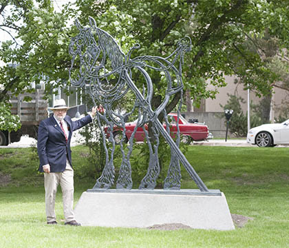 Dr. Don Hamilton stands beside Bonnie Bucklyvie, the iron horse statue outside WCVM.Photo: Sarah Figley.