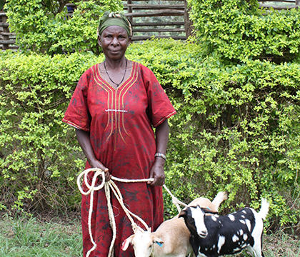 A new beneficiary with her two goats after the 2015 goat pass-out ceremony. Photo by Sarah Zelinski.