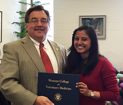 WCVM Dean Dr. Doug Freeman and Kalhari Goonewardene whose research poster earned first prize (immunology/toxicology category) Photo: Dr. Janet Hill.