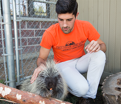 Garrett Fraess with Georgia the picky porcupine. Photo by Caitlin Taylor.