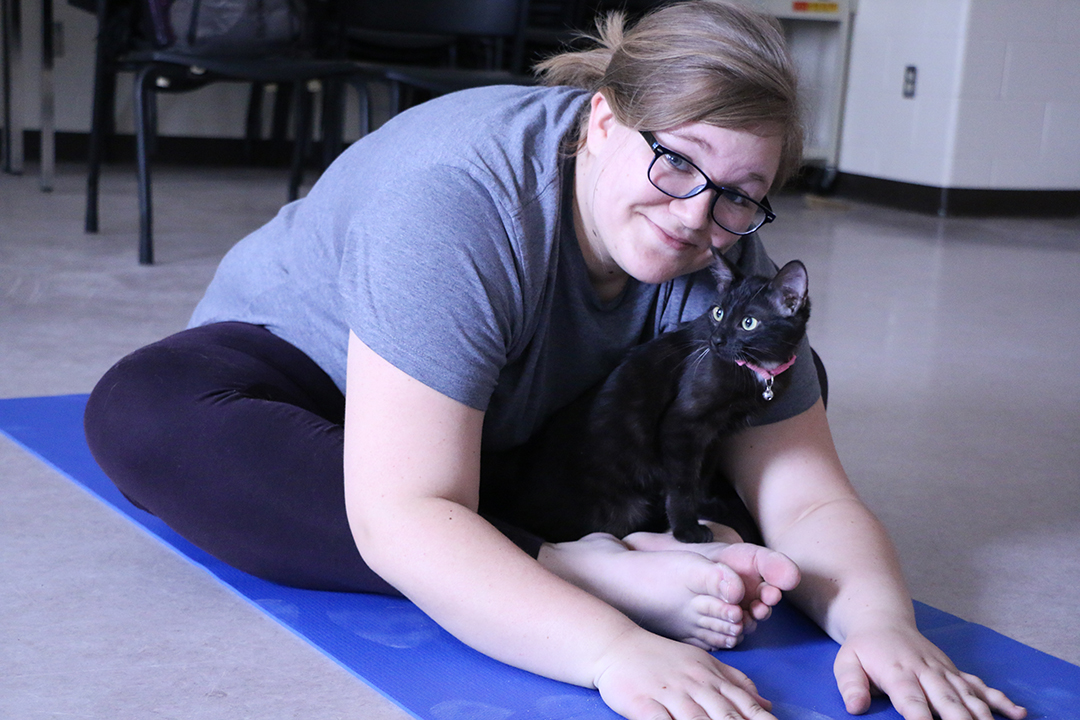 Kendra Elliott, WCVM veterinary student, takes part in the Cat Yoga on Mar. 6. Photos by Taryn Riemer