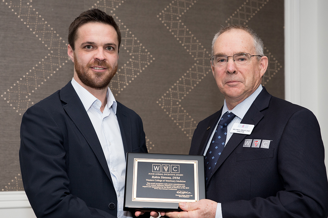 Dr. Rob Stevens (left) accepts a 2019 Food Animal Incentive Award from Dr. William Wright, director of the Western Veterinary Conference (WVC) in February 2019. Supplied photo. 