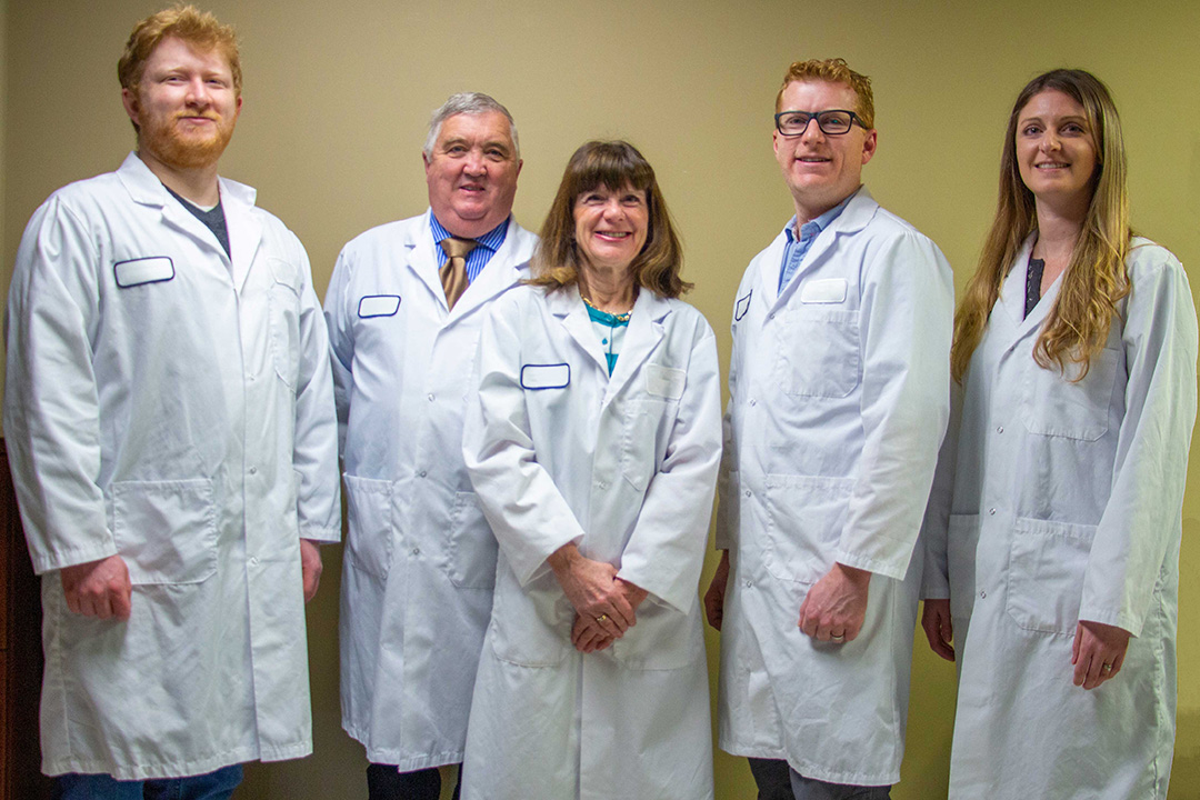 Left to right: Production Manager Anders Olson, Co-Owner and Director of Research Dr. Merle Olson, Co-Owner and Director of Quality Assurance Dr. Barbar Olson, Operations Manager Adam Olson, Finance Manager Samantha Olson. 