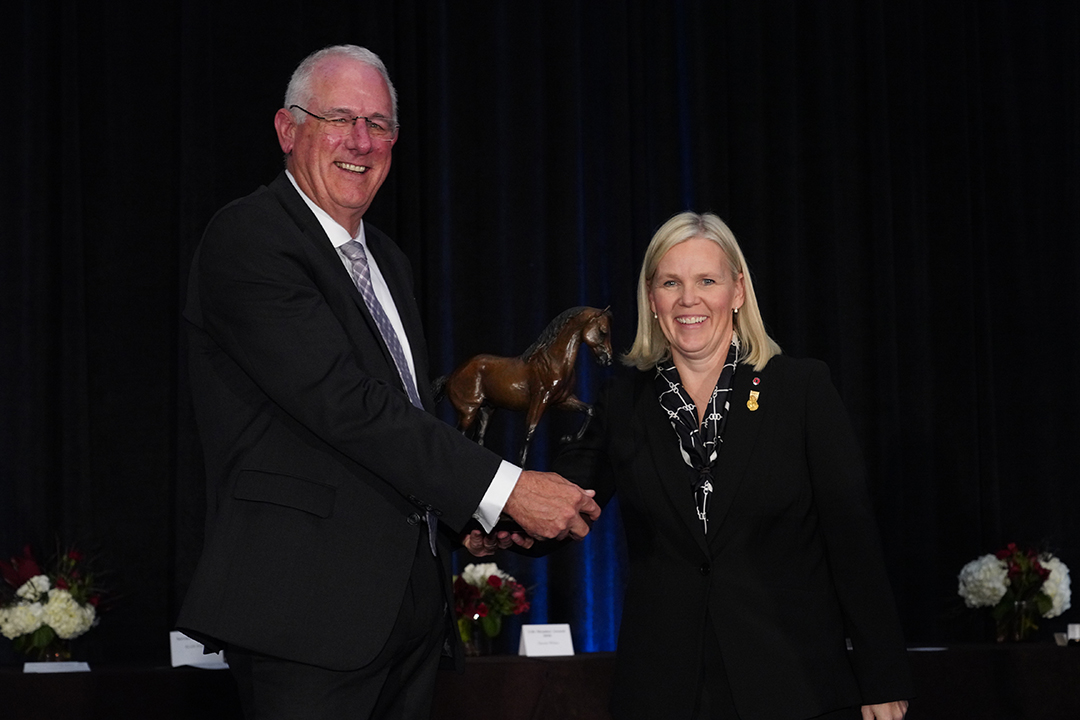 Outgoing AAEP president Dr. Scott Hay welcomes Dr. Emma Read as the organization's new president. Photo: AAEP.