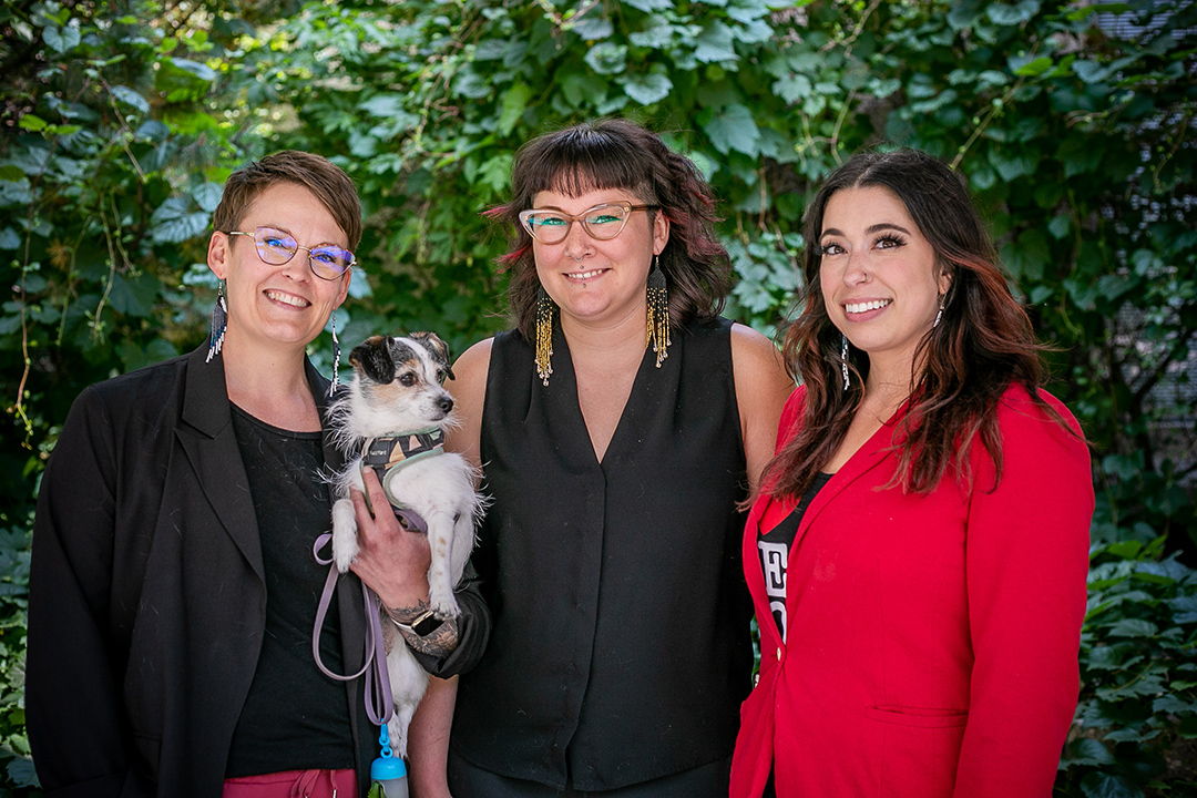 Left to right: Dr. Jordan Woodsworth, NECO director, with her northern dog Polly; Katara Chanin, registered veterinary technologist for NECO; and Paiten Viklund, administrator for NECO. Photo: Christina Weese. 