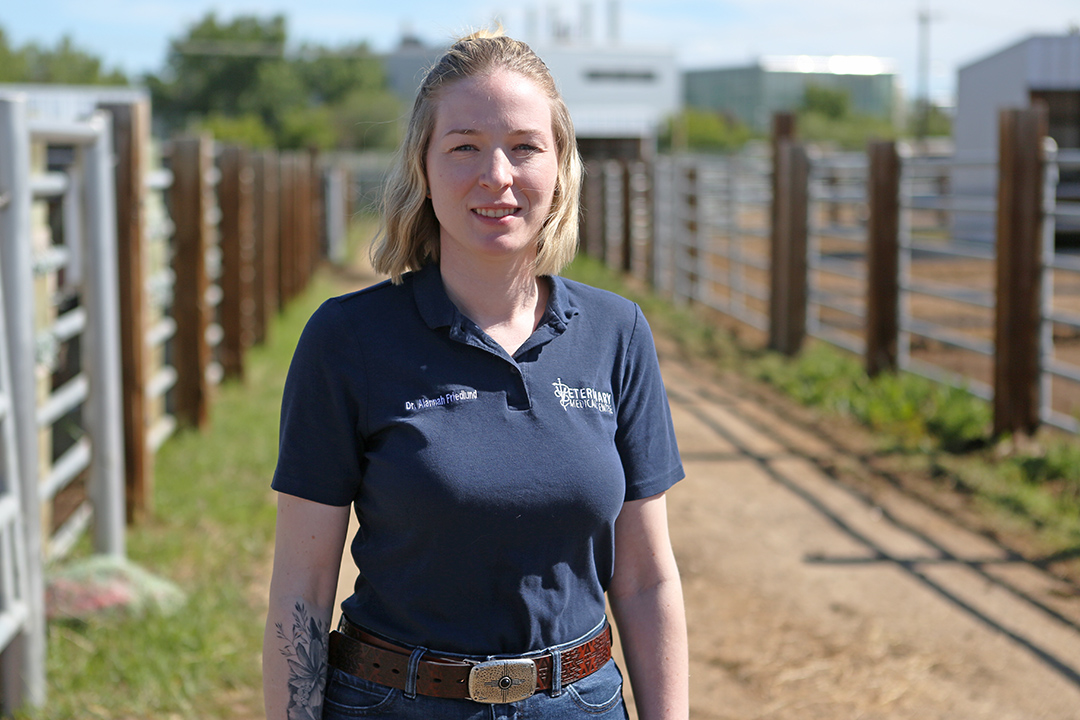 Dr. Alannah Friedlund standing in front of paddock area