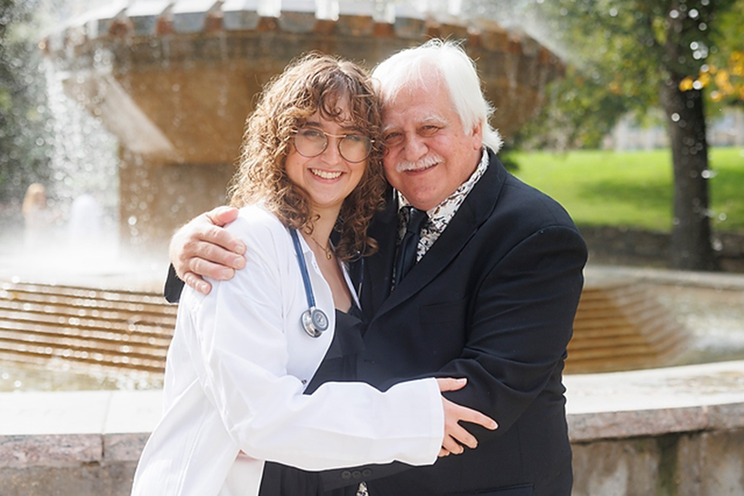 Rory Langelier and her grandfather, Dr. Ken Langelier (DVM'81), share a hug after the WCVM's White Coat Ceremony on Sept. 23. Photo: Dave Stobbe. 