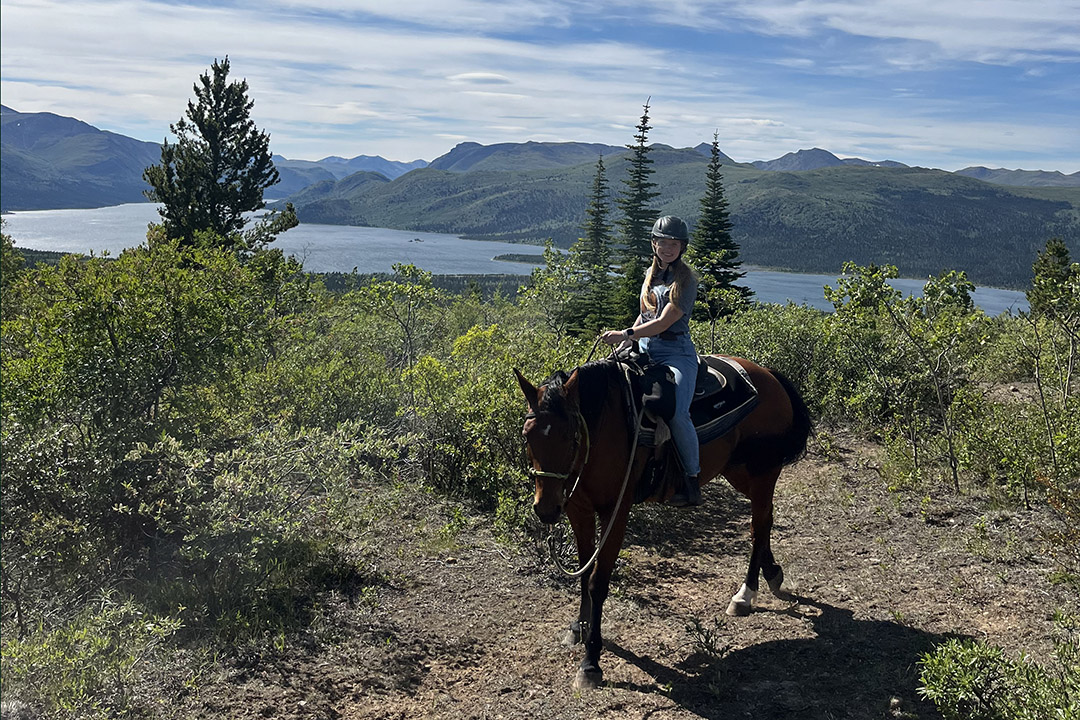 Veterinary student Claire Campbell on horseback in the Rocky Mountains