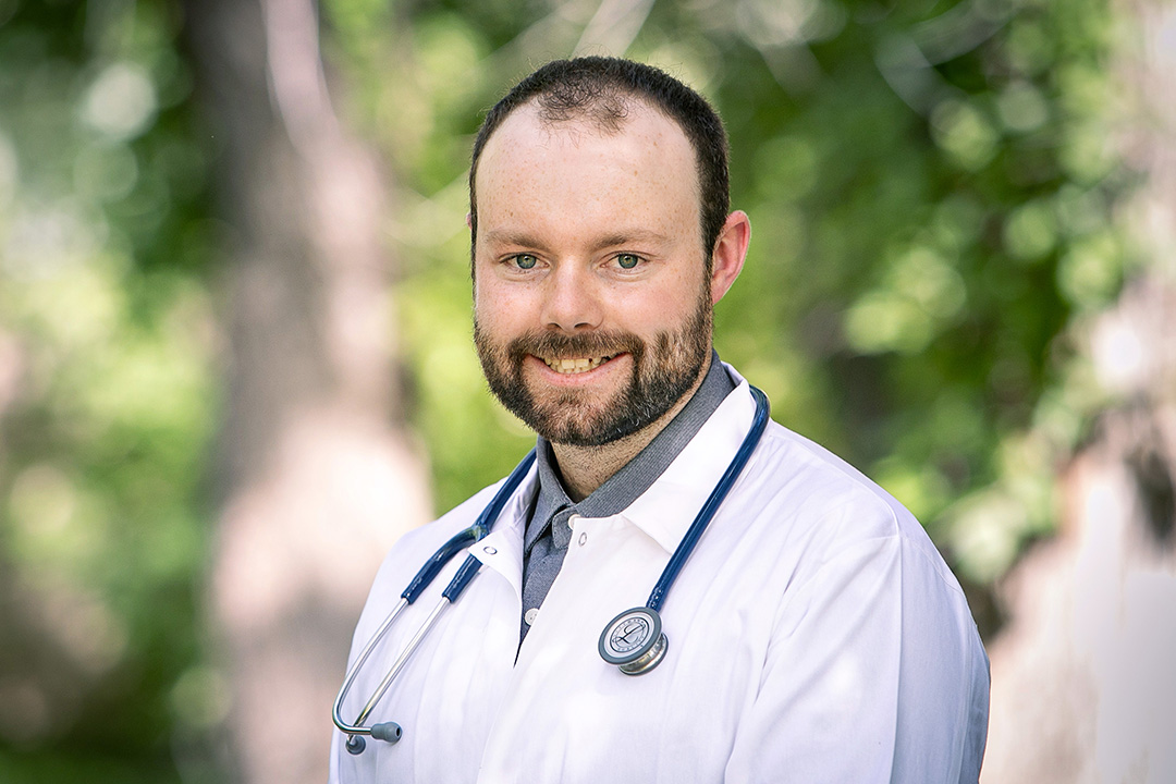 Vet student Matthew Wilson in white lab coat